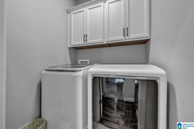 laundry room with cabinets and washer and dryer