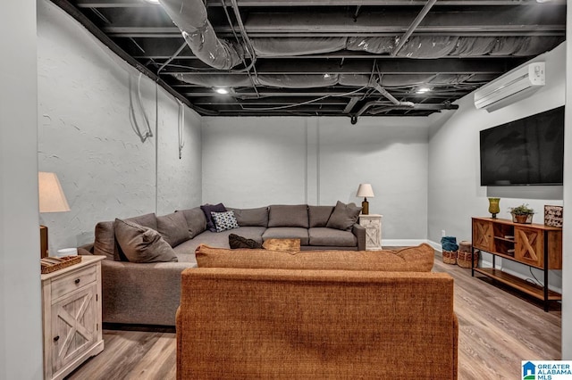 living room with hardwood / wood-style flooring and a wall unit AC