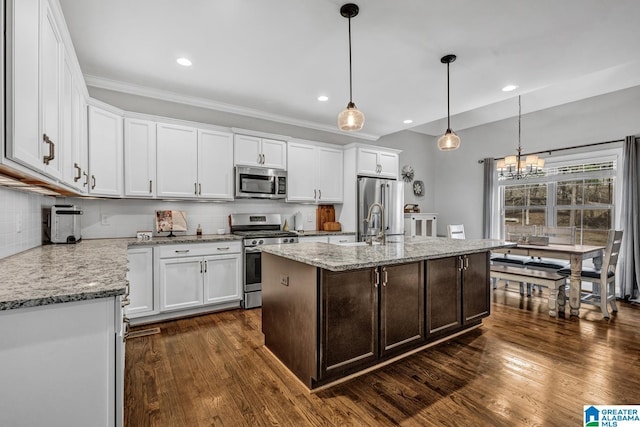 kitchen with a kitchen island with sink, white cabinetry, and appliances with stainless steel finishes