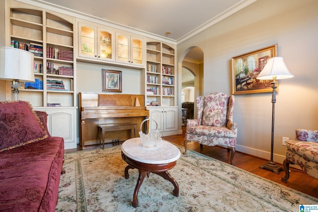 sitting room with crown molding and hardwood / wood-style flooring