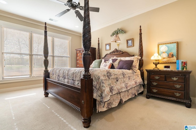 carpeted bedroom with ornamental molding and ceiling fan