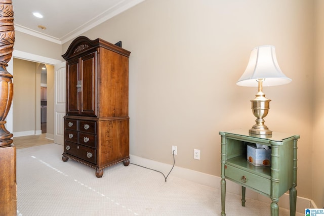 sitting room featuring light carpet and ornamental molding