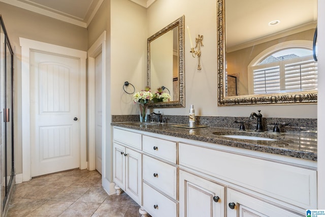 bathroom with tile patterned flooring, vanity, and crown molding