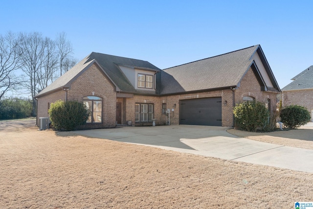 view of front of property featuring cooling unit and a garage