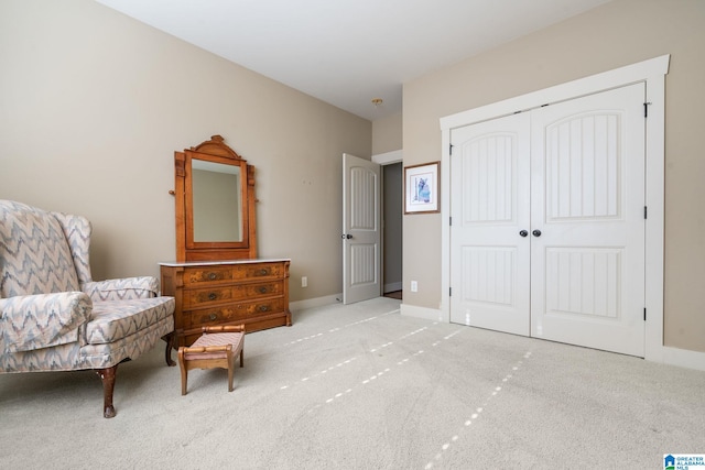 sitting room featuring light colored carpet