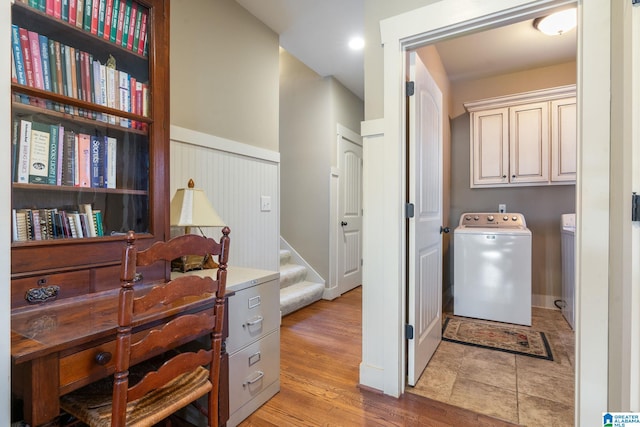 laundry room with independent washer and dryer, cabinets, and light hardwood / wood-style floors