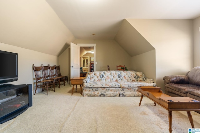 living room featuring carpet flooring and vaulted ceiling