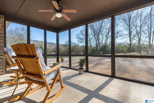 sunroom featuring ceiling fan and a healthy amount of sunlight