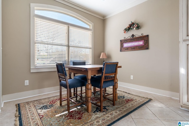 dining area featuring crown molding and light tile patterned floors