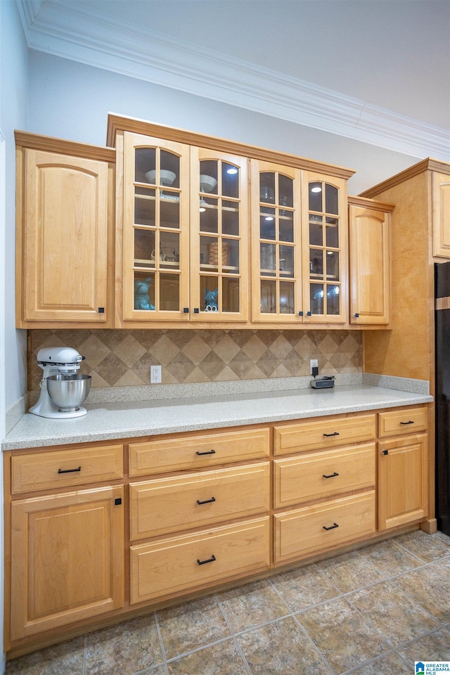 kitchen featuring crown molding, light brown cabinetry, and decorative backsplash