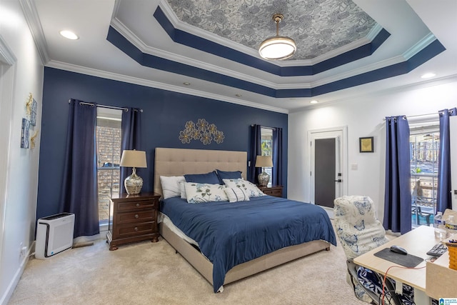 carpeted bedroom featuring ornamental molding and a tray ceiling