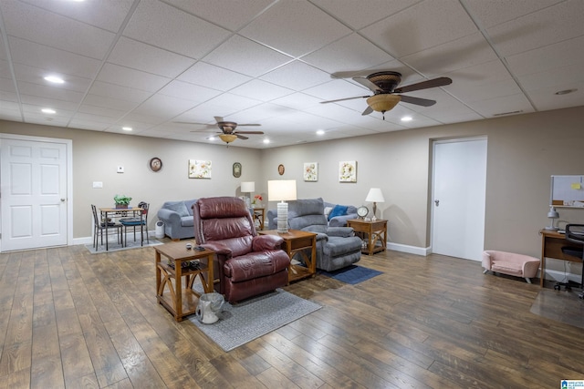 living room with ceiling fan and dark hardwood / wood-style floors