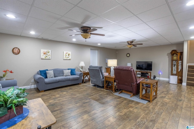 living room featuring dark hardwood / wood-style floors, a paneled ceiling, and ceiling fan