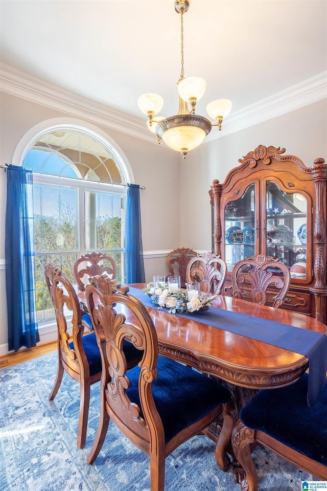 dining space featuring hardwood / wood-style floors and crown molding