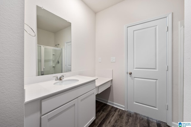 bathroom featuring vanity, hardwood / wood-style floors, and walk in shower