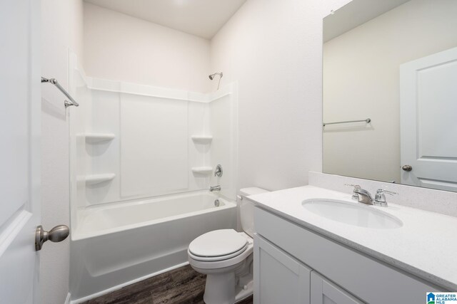 full bathroom featuring vanity, wood-type flooring, bathtub / shower combination, and toilet