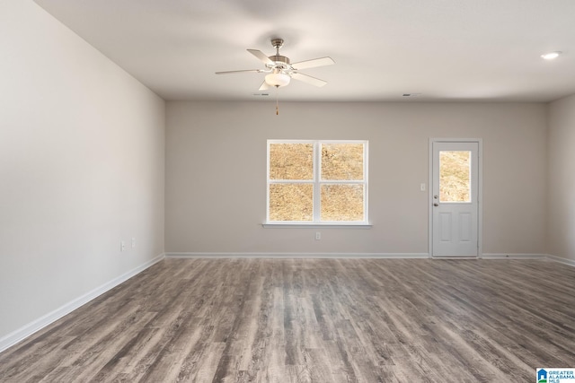 spare room featuring hardwood / wood-style flooring and ceiling fan