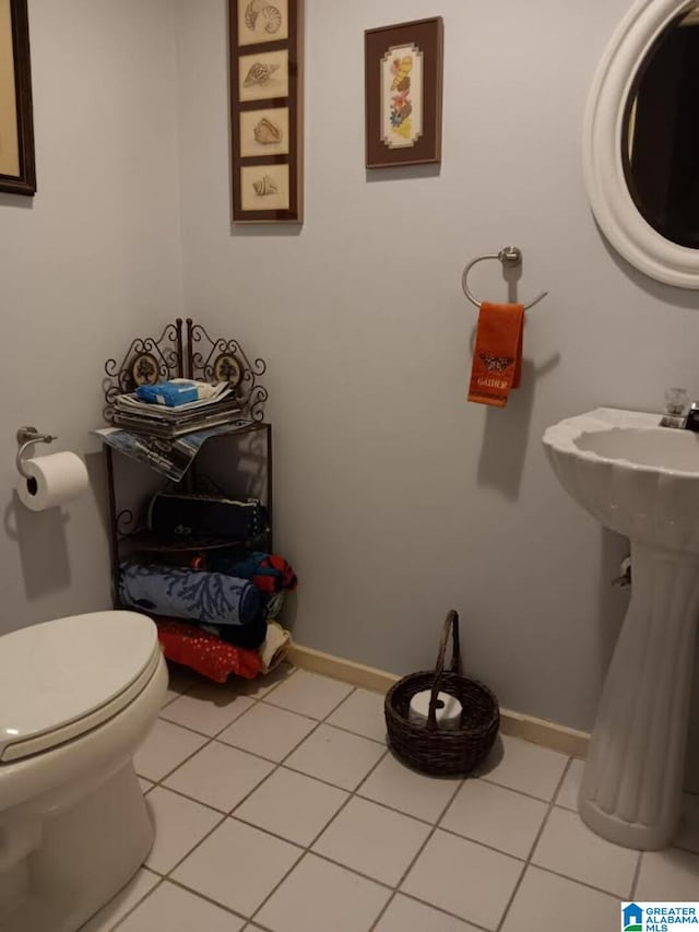 bathroom featuring tile patterned flooring, sink, and toilet