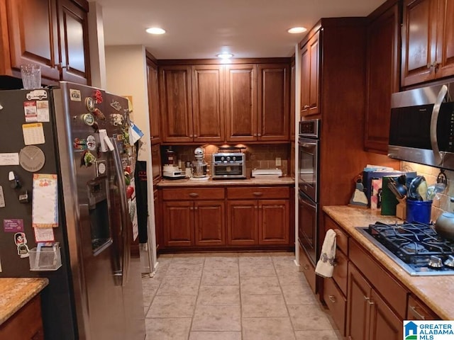 kitchen featuring stainless steel appliances and backsplash