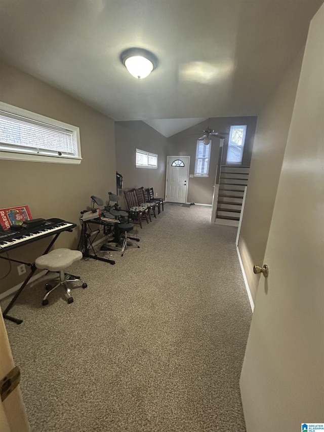 workout room with vaulted ceiling and carpet