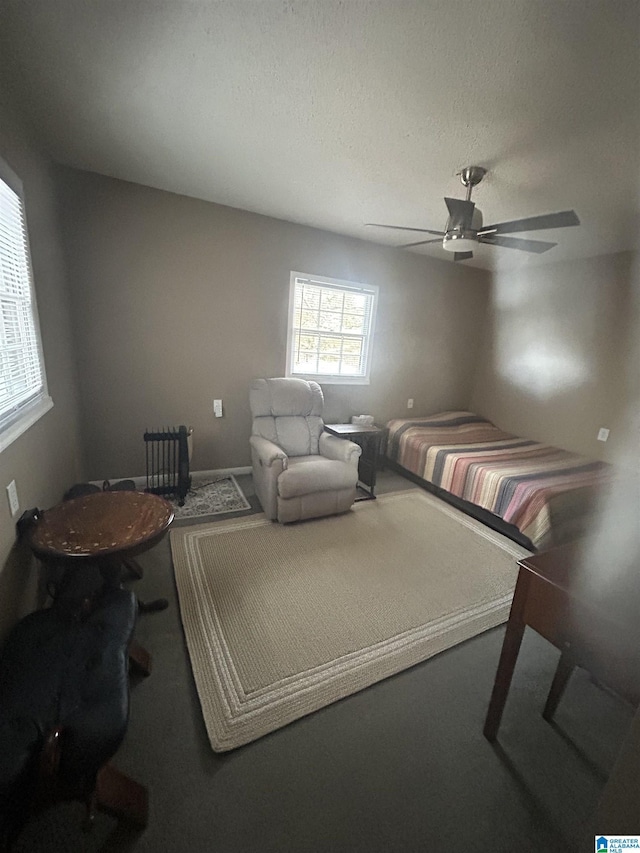 bedroom featuring a textured ceiling and ceiling fan