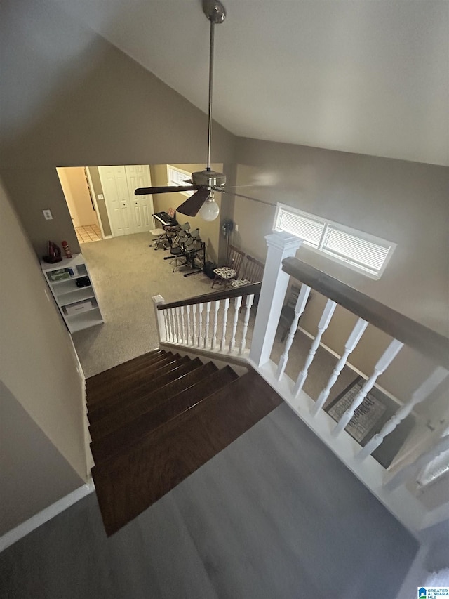 stairs with vaulted ceiling, carpet flooring, and ceiling fan