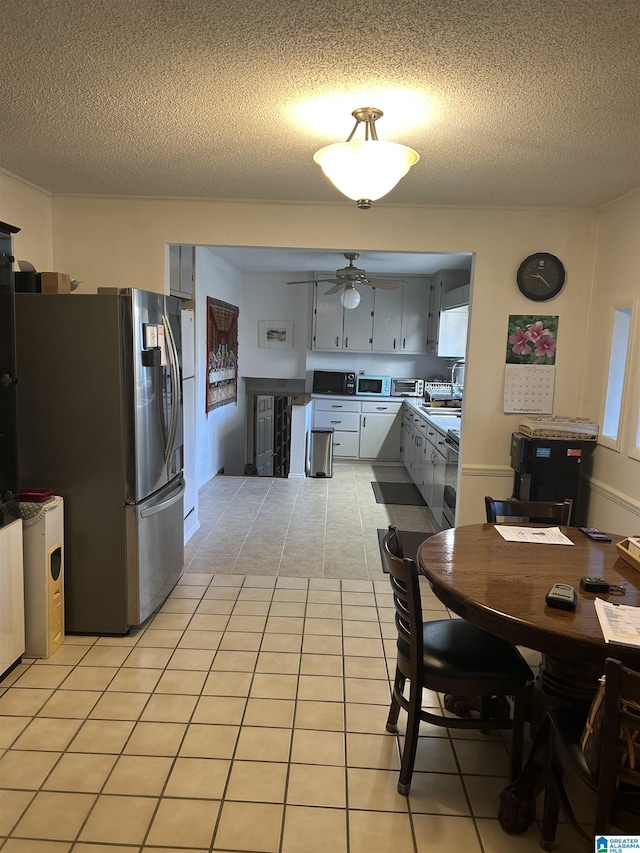 kitchen featuring gray cabinetry, stainless steel appliances, a textured ceiling, and light tile patterned flooring