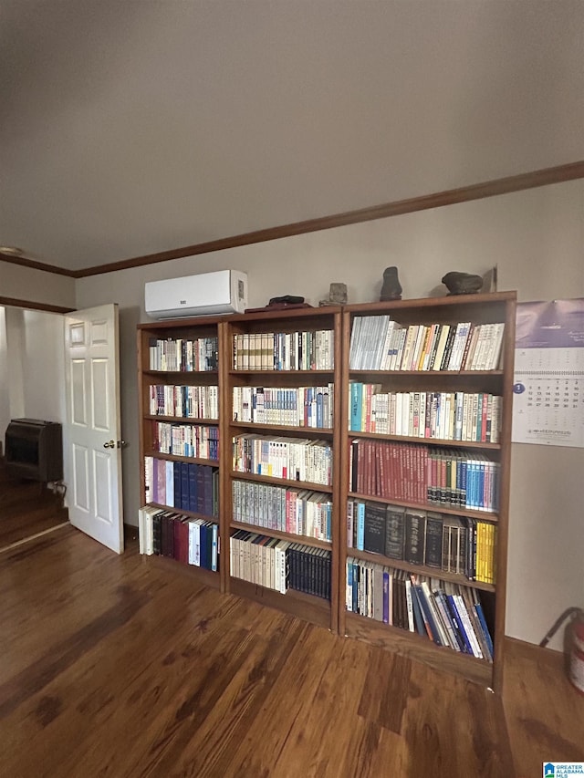 room details with hardwood / wood-style flooring, crown molding, and a wall mounted air conditioner