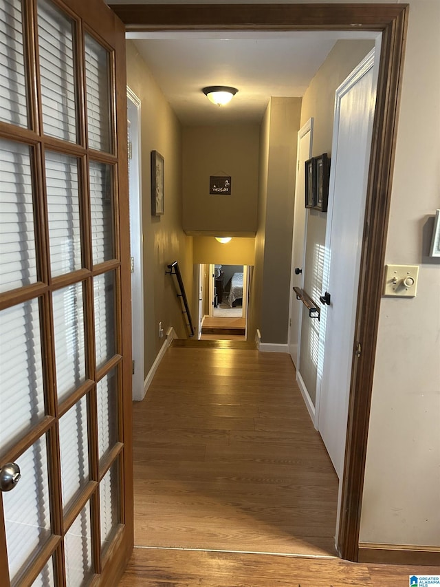 corridor with hardwood / wood-style floors