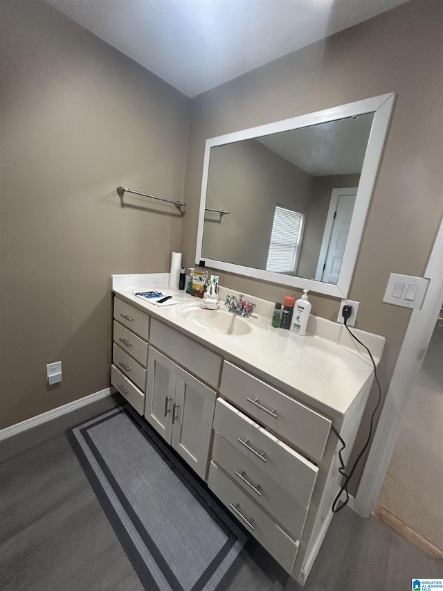 bathroom featuring vanity and hardwood / wood-style floors