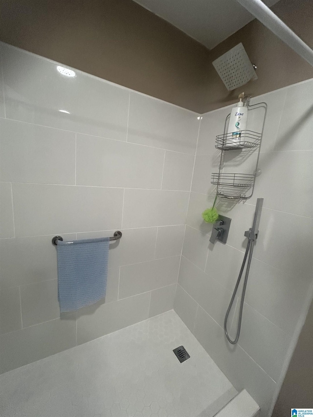 bathroom with tiled shower