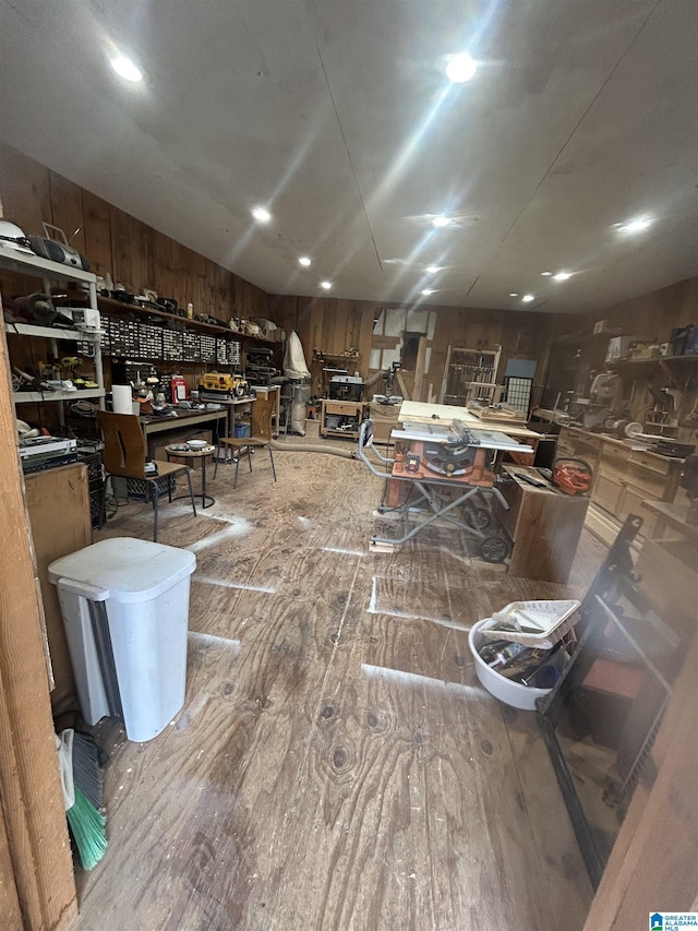 misc room featuring wood-type flooring and a workshop area