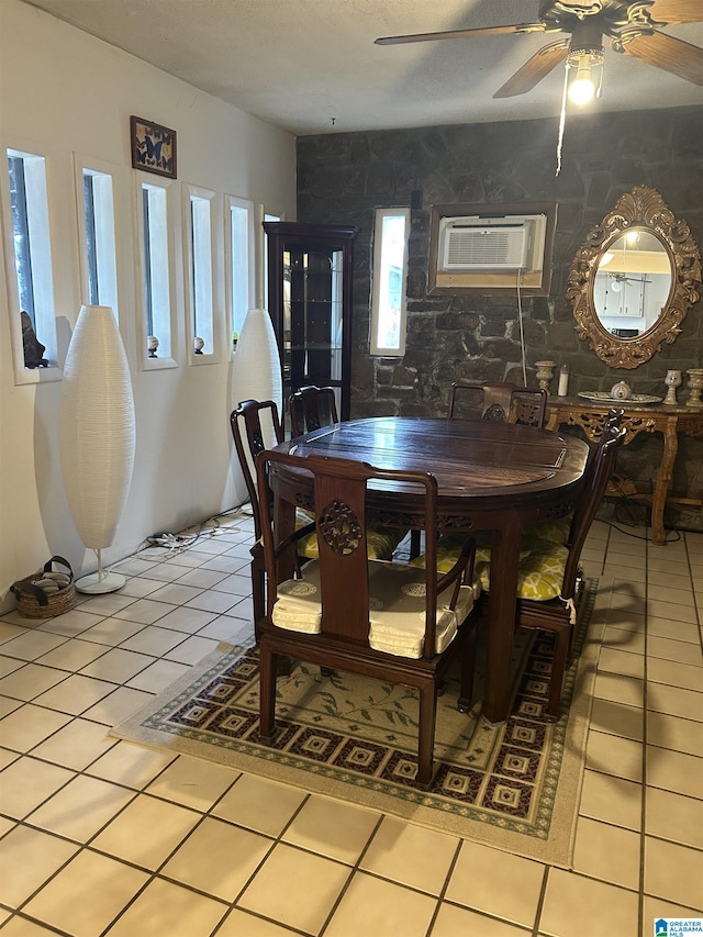 tiled dining area with a wall mounted air conditioner and ceiling fan