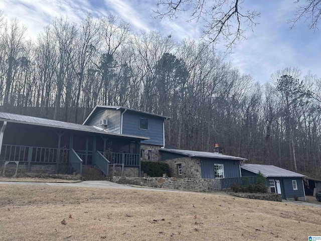 view of front of property with a front yard and covered porch