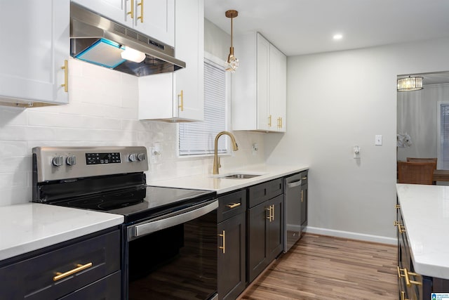 kitchen featuring white cabinetry, sink, stainless steel appliances, light stone countertops, and light hardwood / wood-style flooring