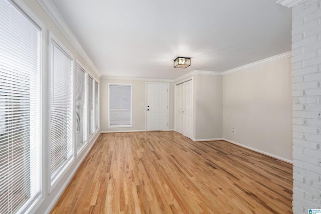 interior space with ornamental molding and light wood-type flooring