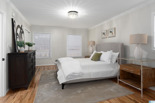 bedroom with crown molding and light wood-type flooring