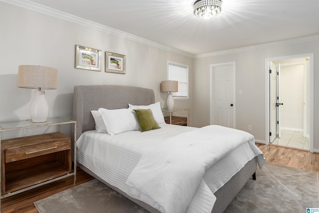 bedroom with hardwood / wood-style flooring and ornamental molding