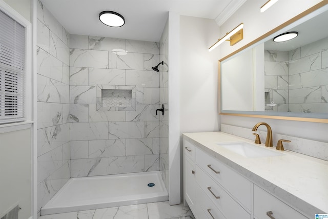 bathroom with vanity and a tile shower