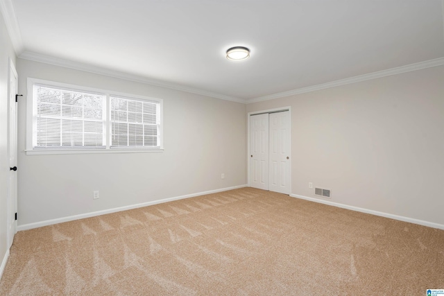 carpeted spare room with crown molding