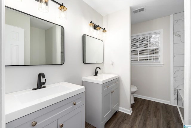 bathroom featuring vanity, toilet, and hardwood / wood-style floors