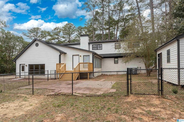 rear view of property featuring cooling unit, a yard, and a patio area