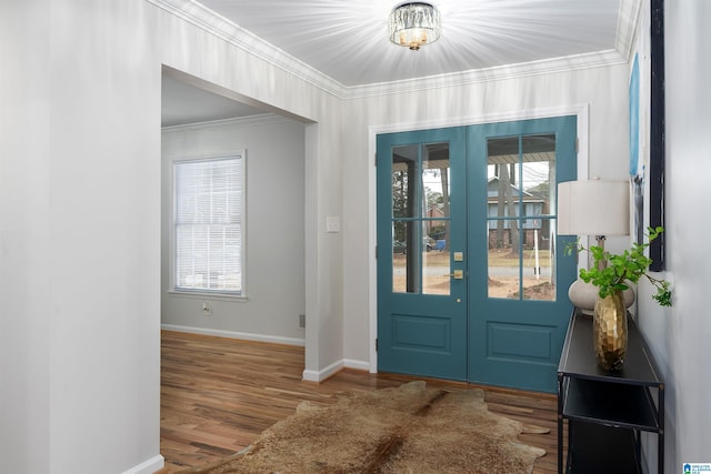 foyer entrance featuring french doors, ornamental molding, and hardwood / wood-style flooring