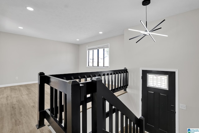 interior space with recessed lighting, an inviting chandelier, baseboards, and wood finished floors