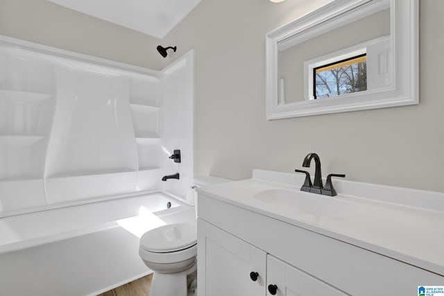 full bathroom featuring  shower combination, wood finished floors, vanity, and toilet