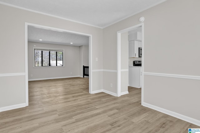 empty room with light wood-type flooring and baseboards