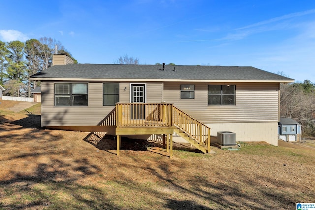 rear view of house featuring roof with shingles, a chimney, central air condition unit, a deck, and stairs