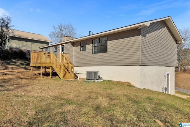 rear view of house with cooling unit, a yard, stairway, a wooden deck, and a chimney