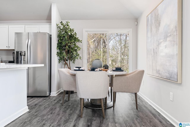 dining room featuring baseboards and dark wood-type flooring