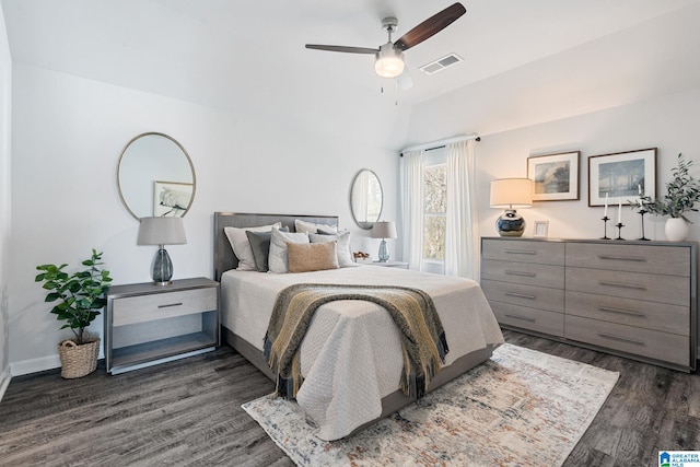 bedroom featuring lofted ceiling, ceiling fan, visible vents, baseboards, and dark wood finished floors